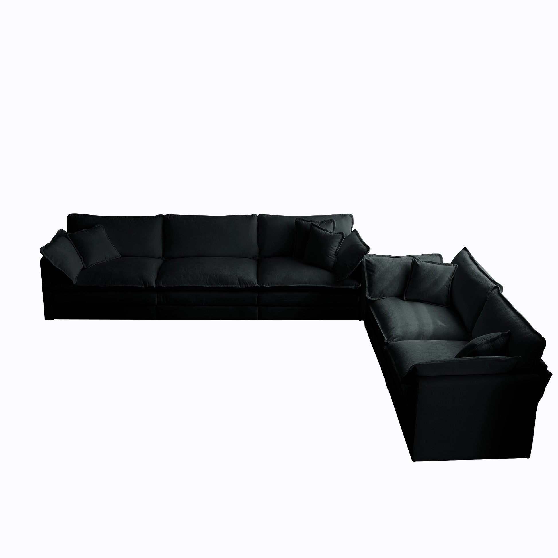 Plush black fabric sectional sofa with deep seating and scattered accent pillows