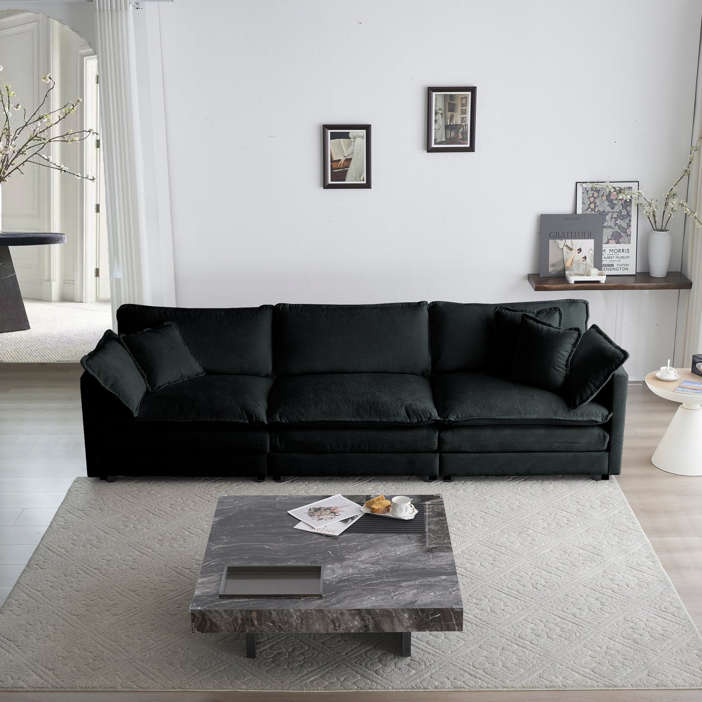 Deep charcoal sectional sofa with plush velvet fabric and matching throw pillows
