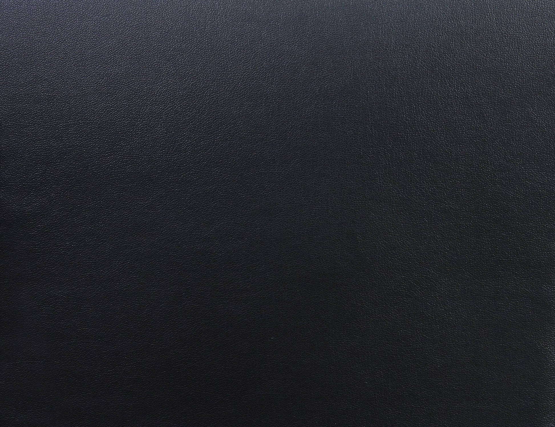 Closeup of textured black faux leather material perfect for upholstery or accessories