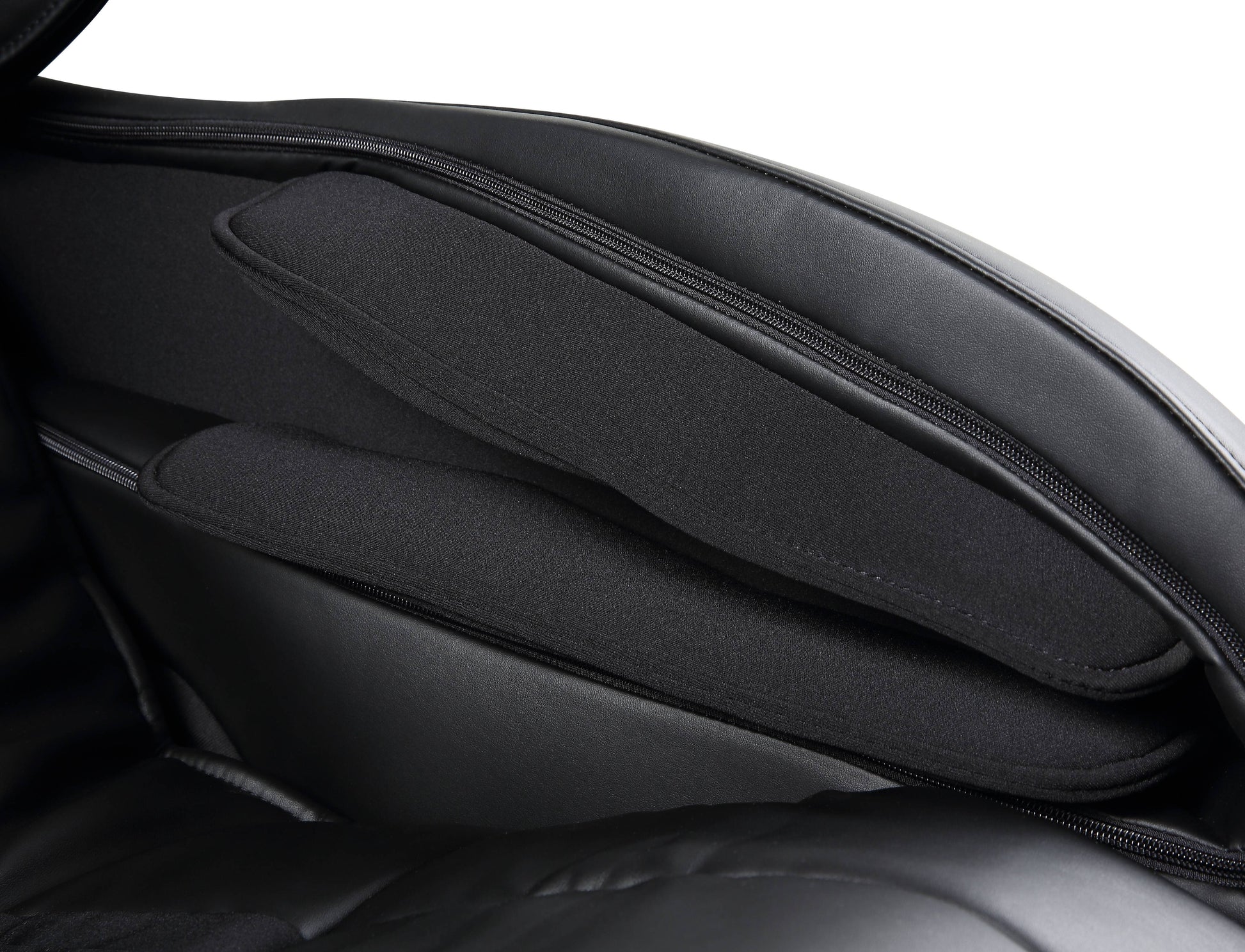 Black leather massage chair interior with padded armrests and zipper details