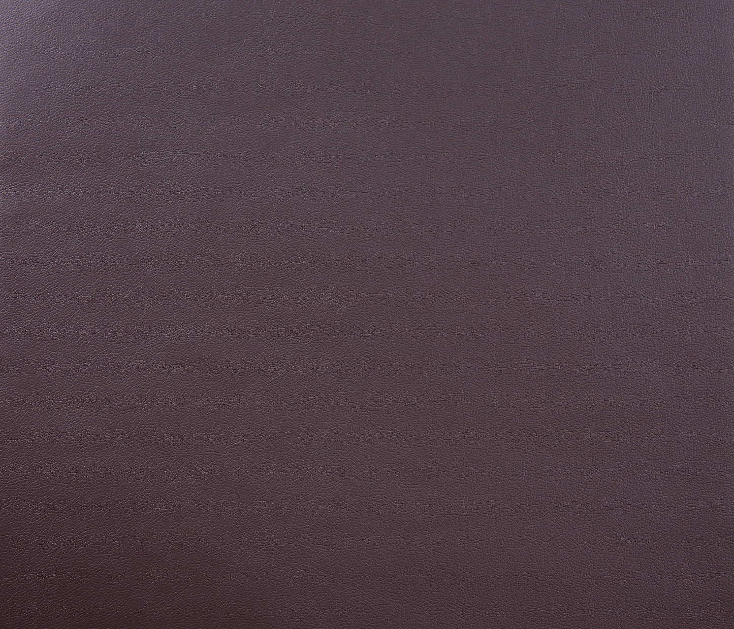 Rich aubergine pebbled leather texture for upholstery or fashion accessories