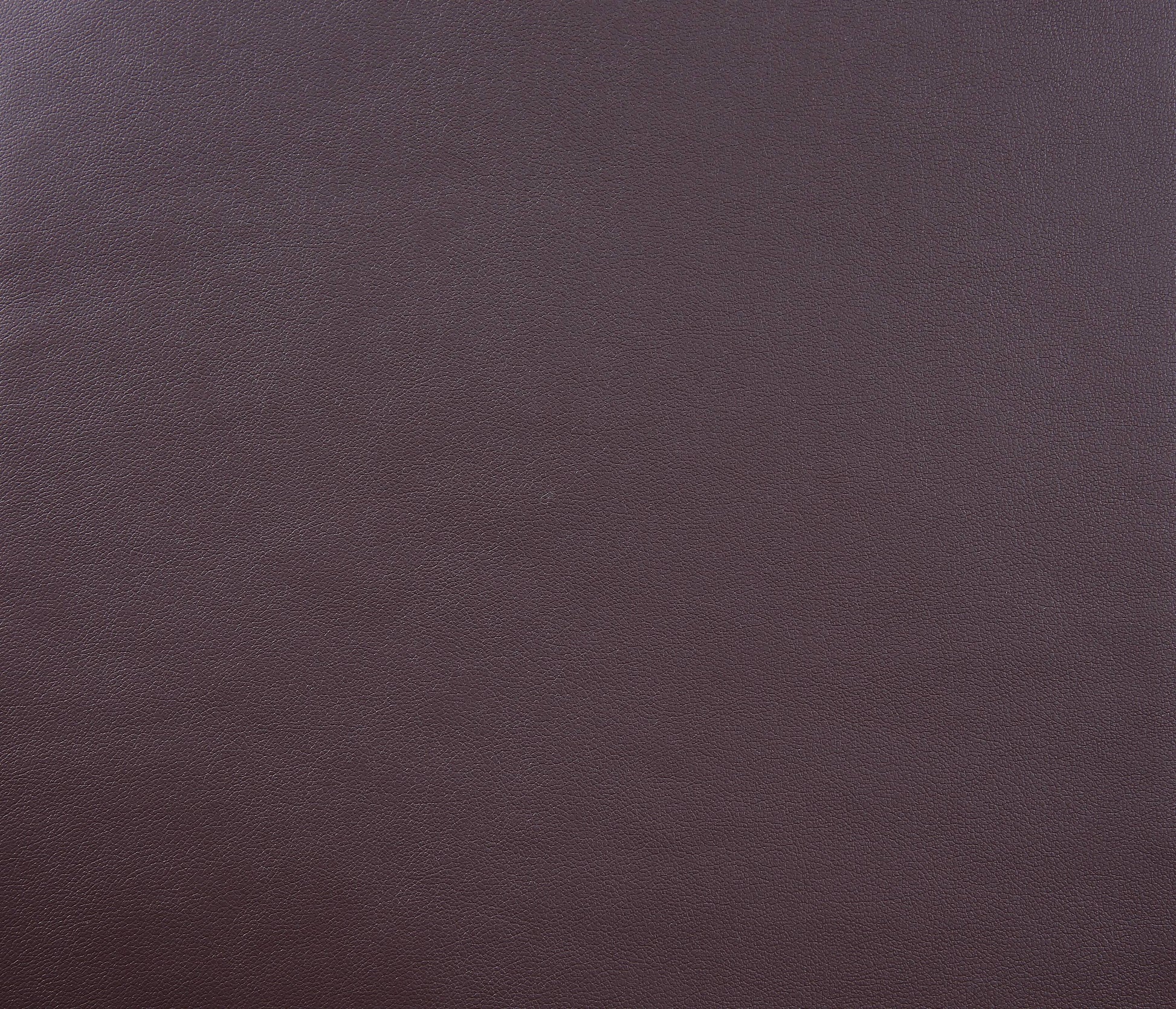 Rich aubergine pebbled leather texture for upholstery or fashion accessories