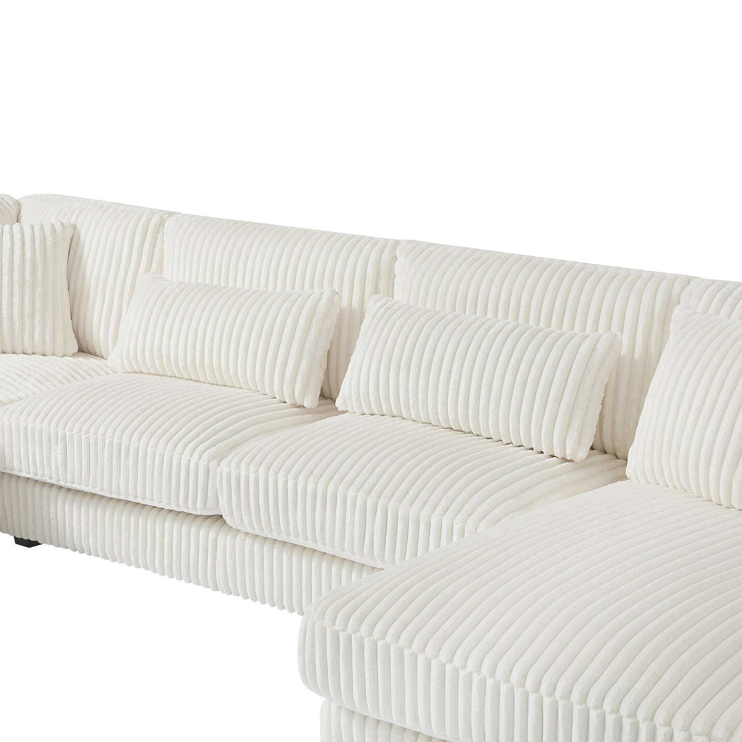 Closeup of a plush white corduroy sectional sofa with matching throw pillows