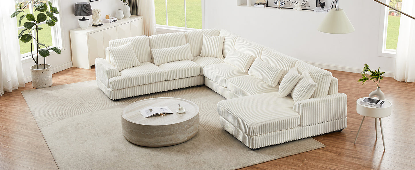 Plush white corduroy sectional sofa with lumbar pillows in a modern living room setting