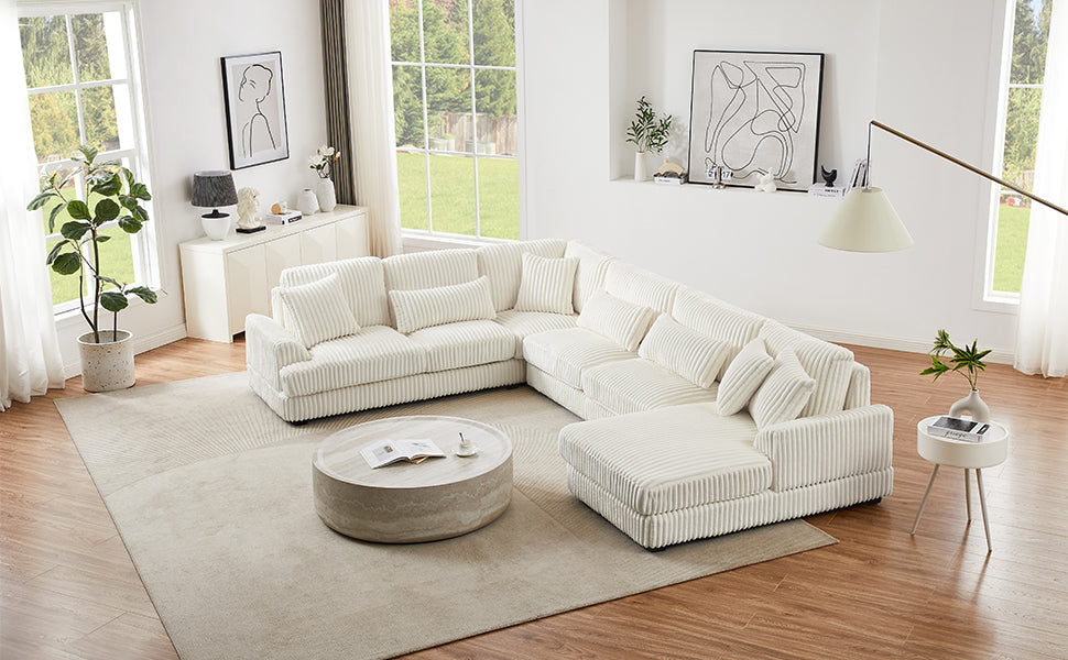 Plush white corduroy sectional sofa with accent pillows in a modern living room