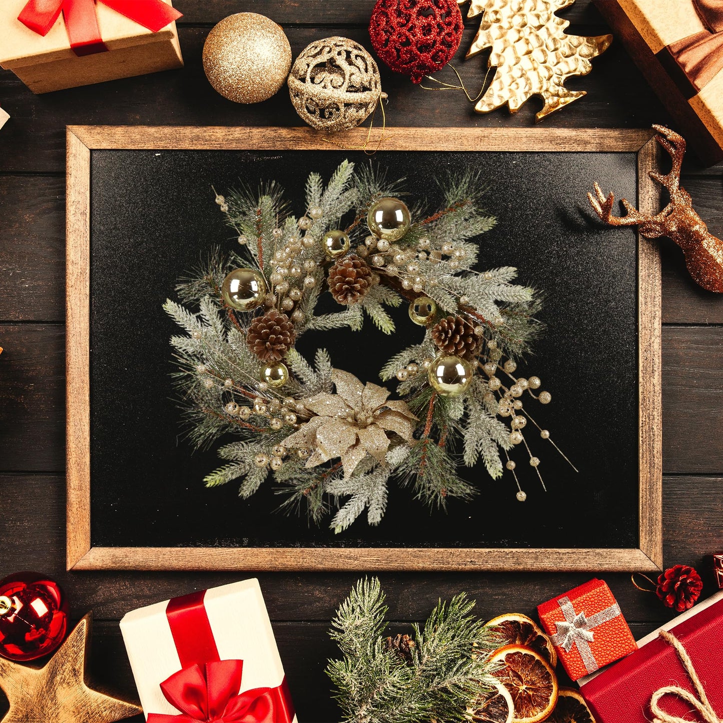 Frosted pine Christmas wreath with gold baubles pine cones and poinsettia