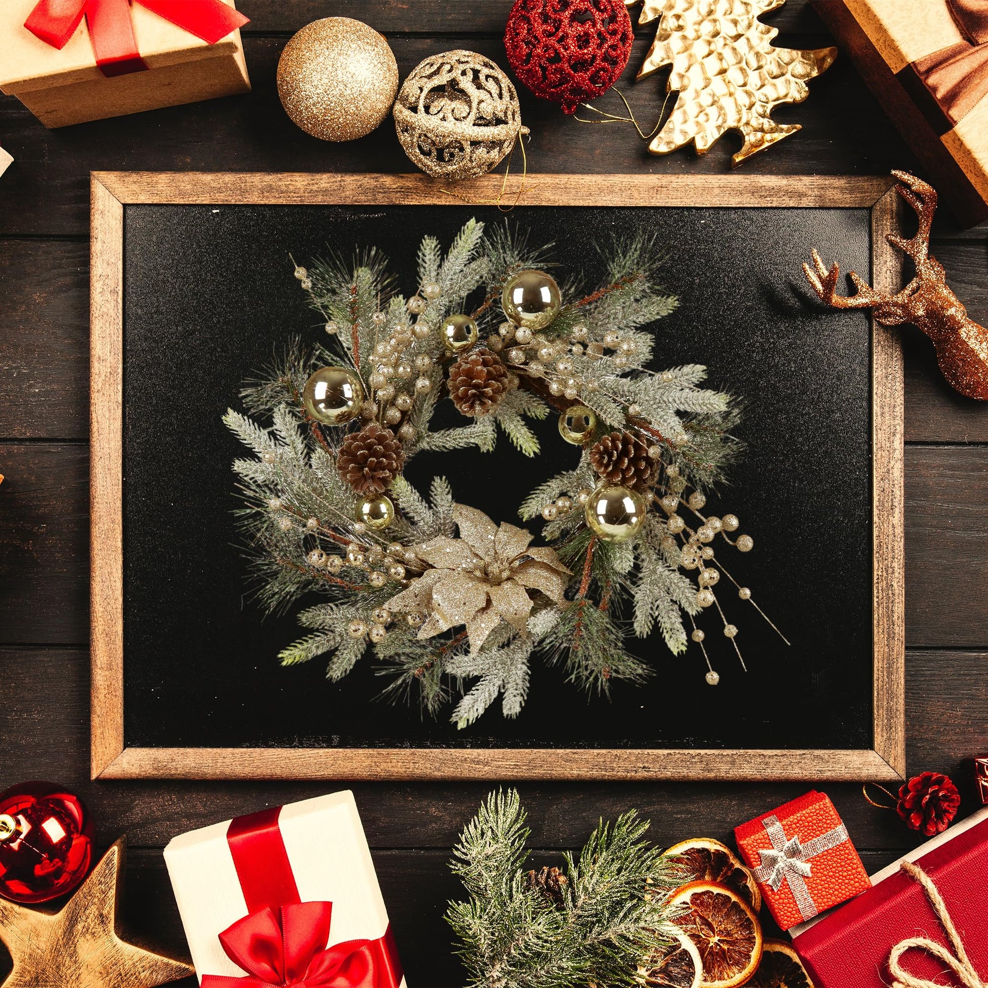 Frosted pine Christmas wreath with gold baubles pine cones and poinsettia
