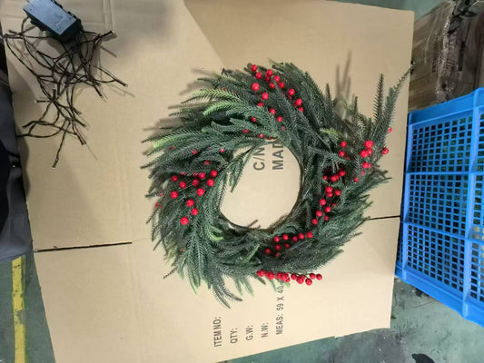 Festive artificial evergreen wreath with bright red berries for holiday decor