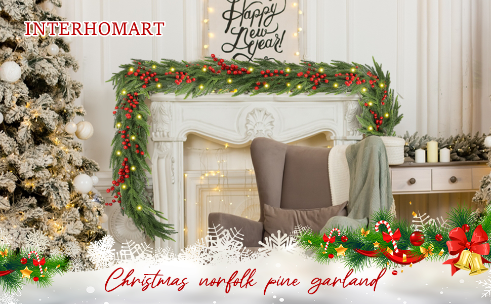 Green fir Christmas garland with red berries and warm LED lights draped over a fireplace