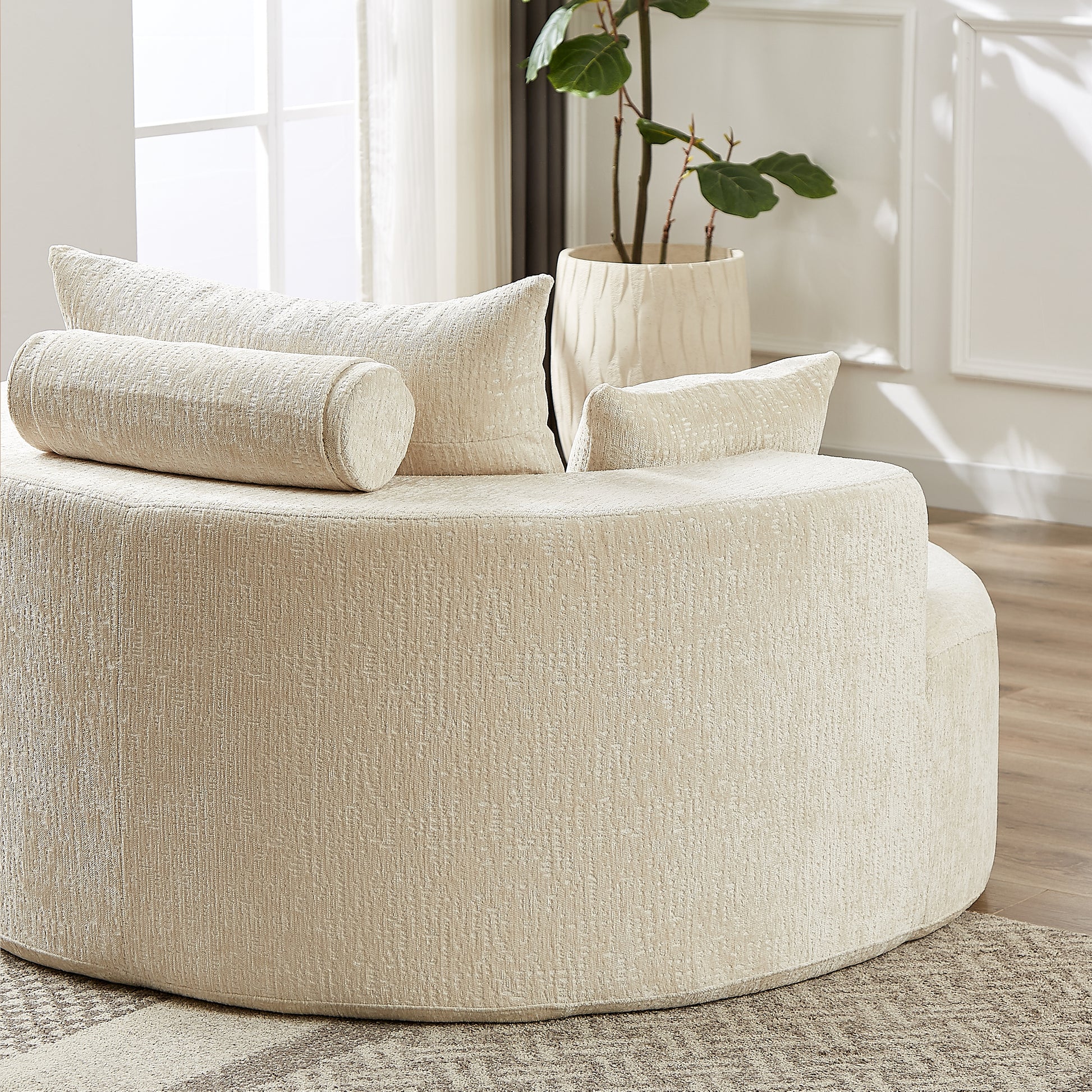 Plush beige boucle fabric accent chair with rounded arms and bolster pillows for luxurious comfort