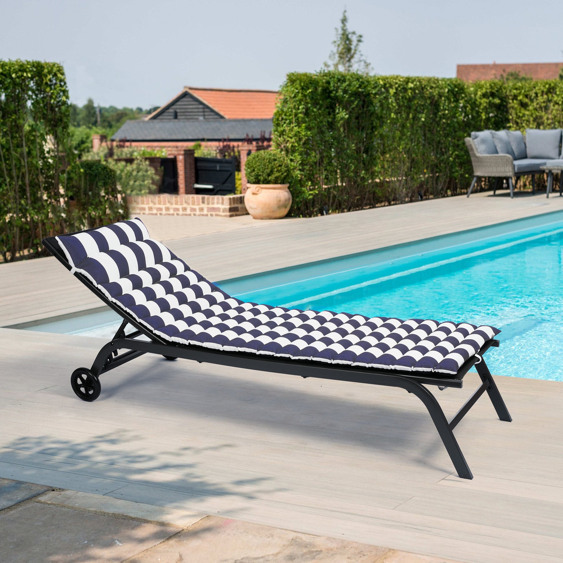 Navy and white striped chaise lounge with black frame perfect for poolside relaxation