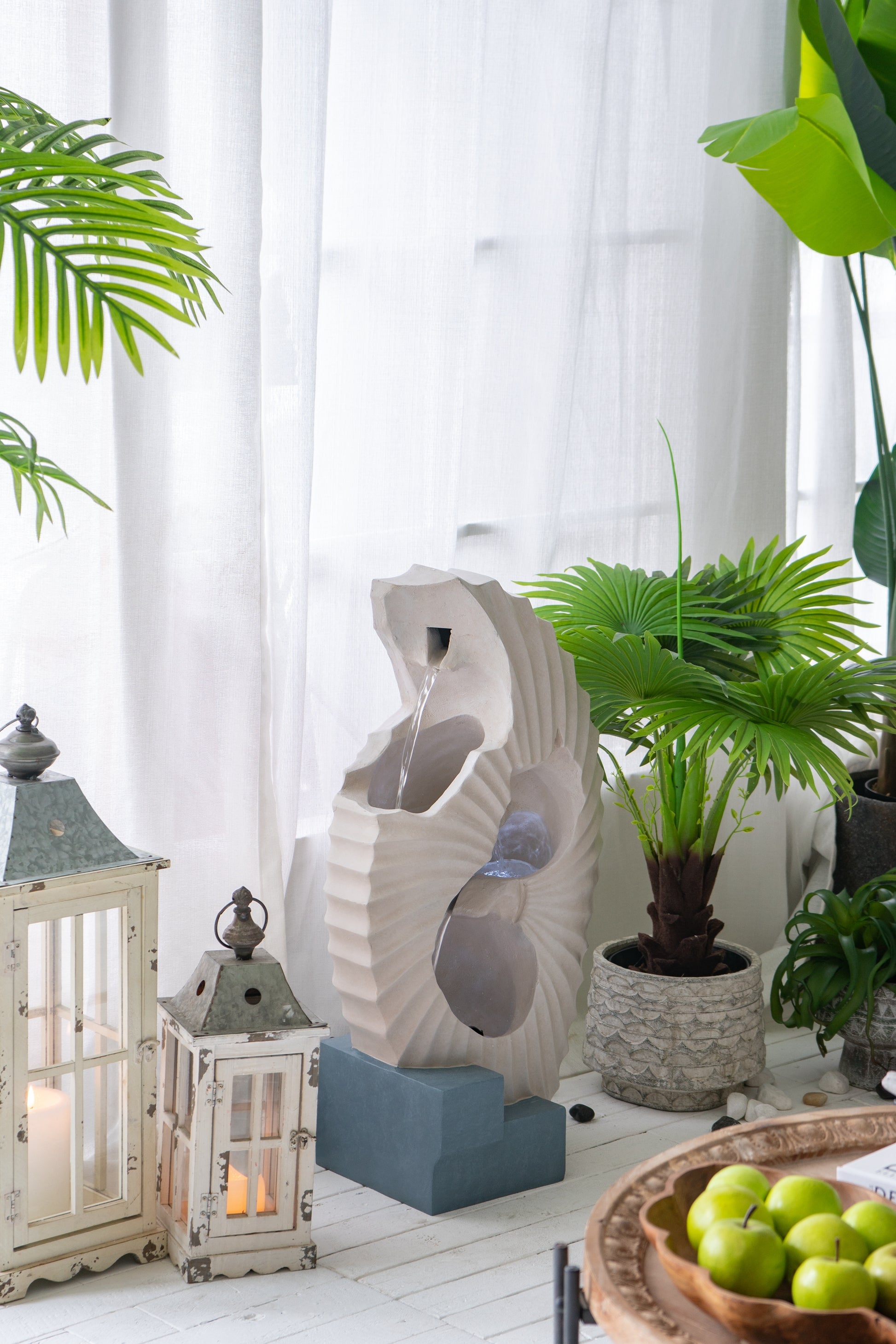 Modern indoor water fountain with a beige abstract sculpture creating a serene ambiance