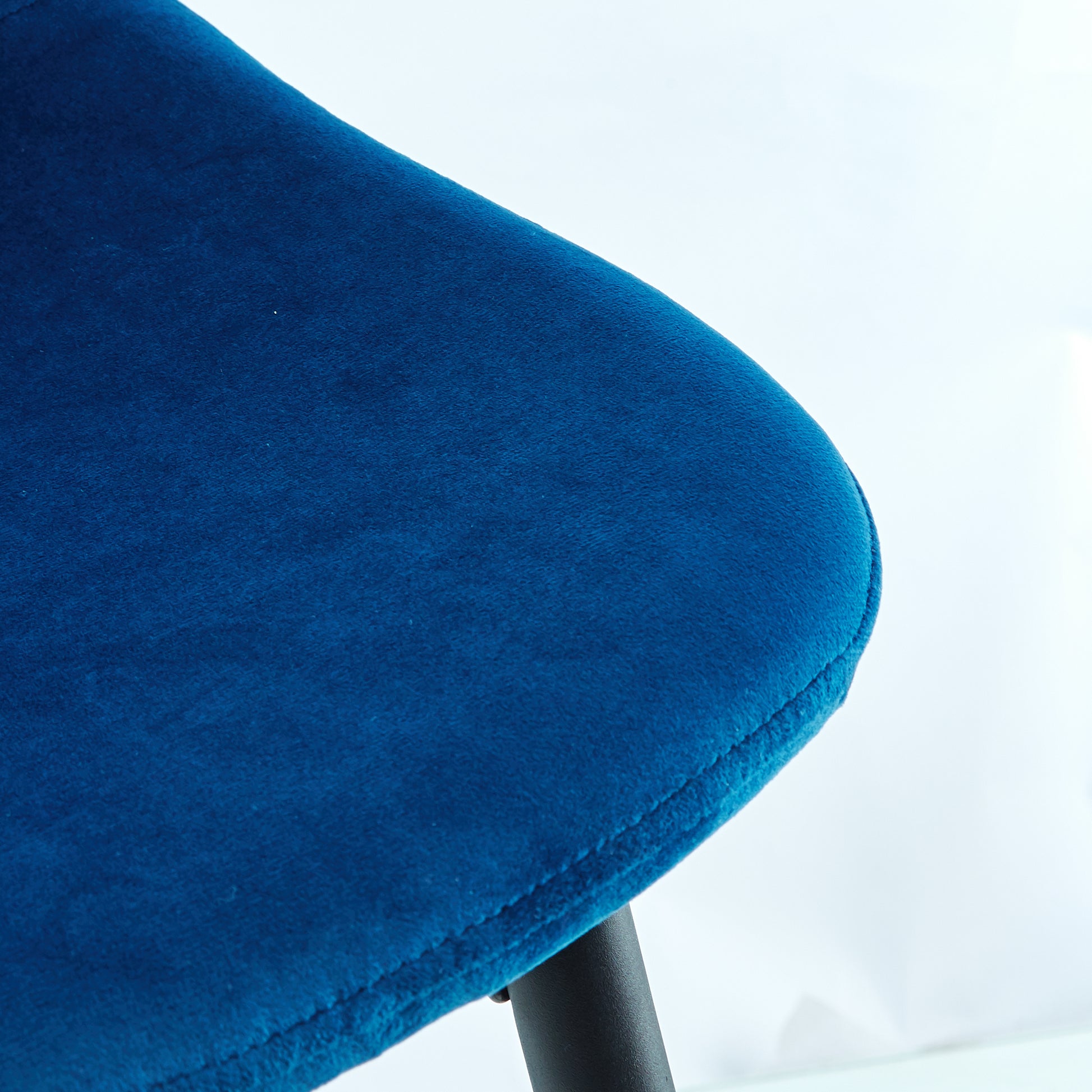 Plush velvet armchair in deep sapphire blue with elegant stitching detail