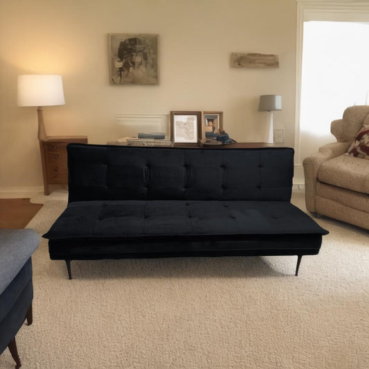Tufted black velvet sofa bed with midcentury modern design and button accents