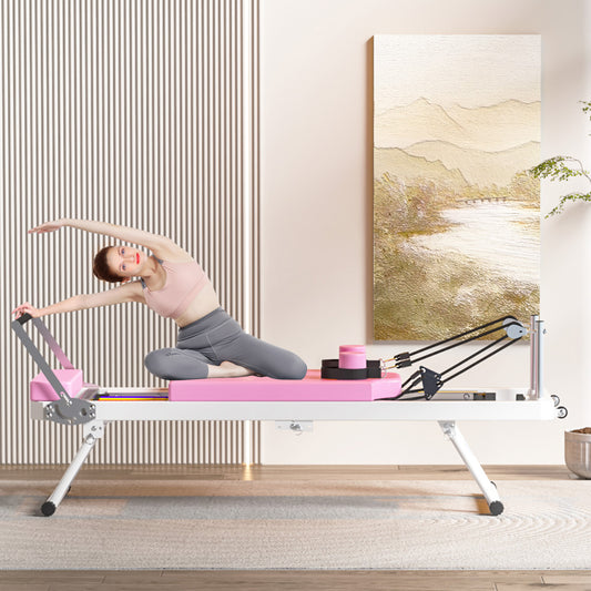 Pink and white Pilates reformer with a woman exercising ideal for home fitness