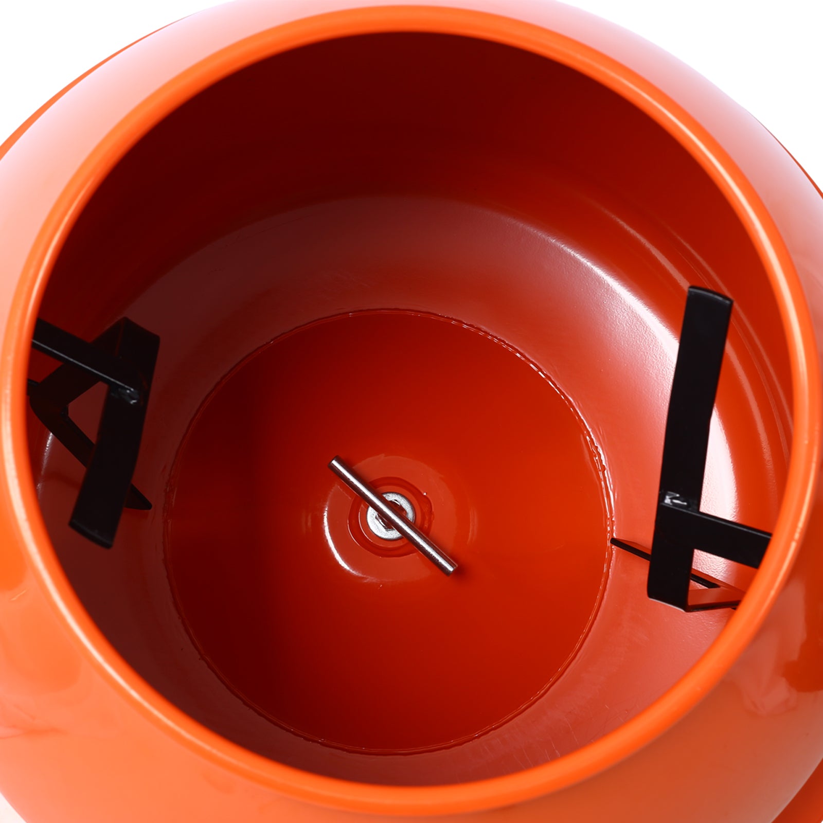 Closeup of an orange cement mixer drum interior with black mixing blades visible