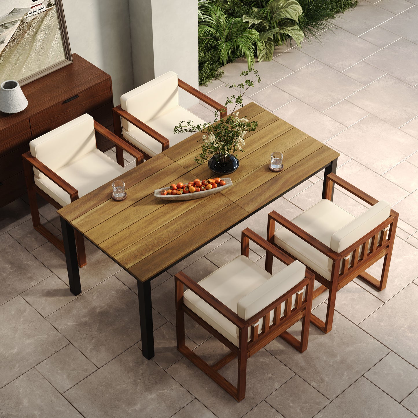 Teak wood outdoor dining table with modern black legs and four upholstered chairs