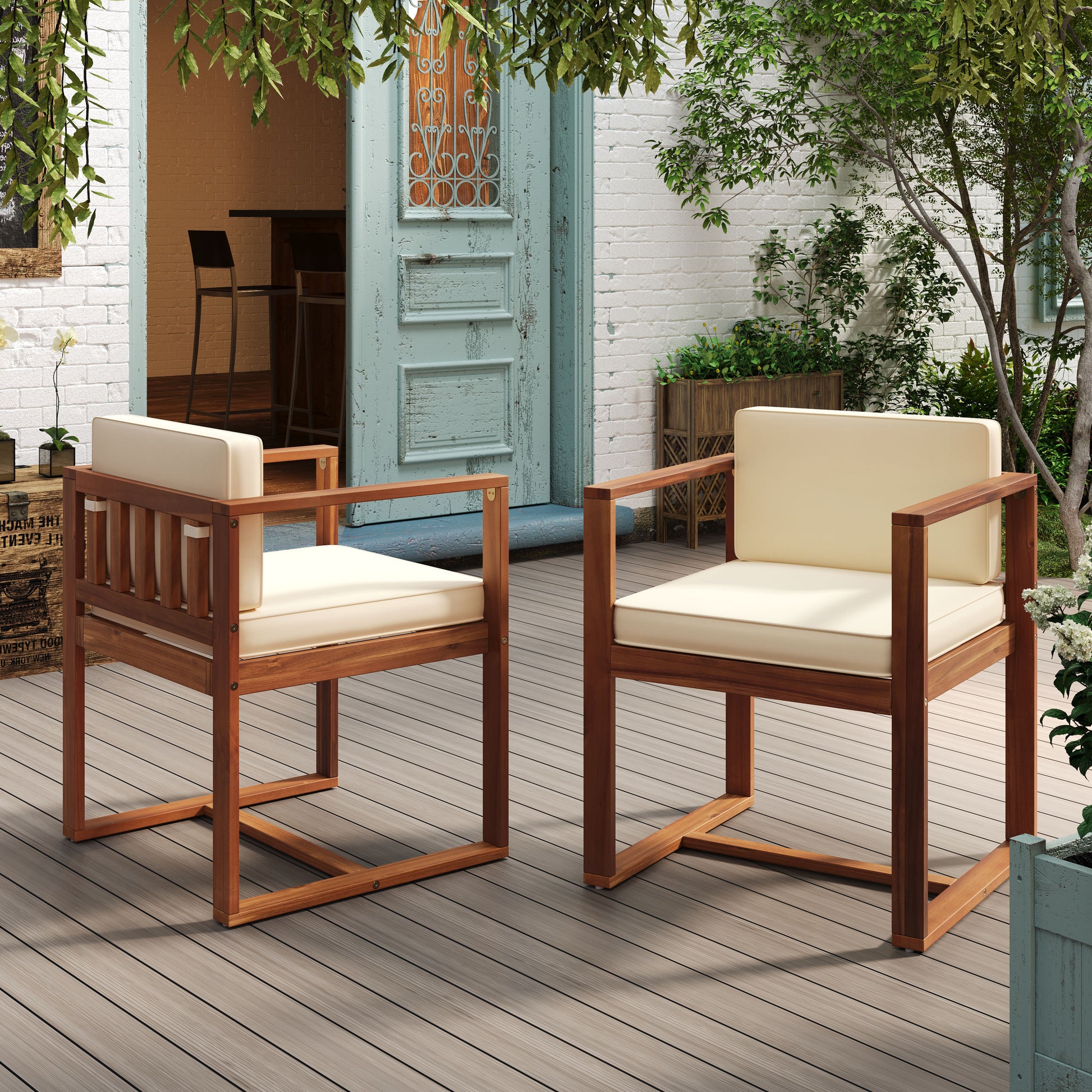 Two modern wooden outdoor chairs with cream cushions on a deck