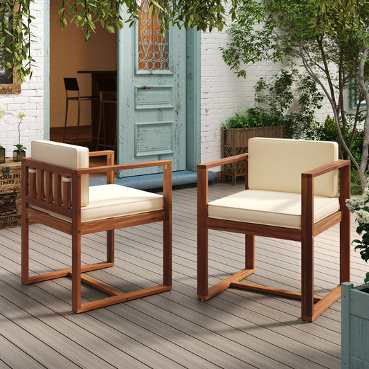 Two modern wooden outdoor chairs with cream cushions on a deck