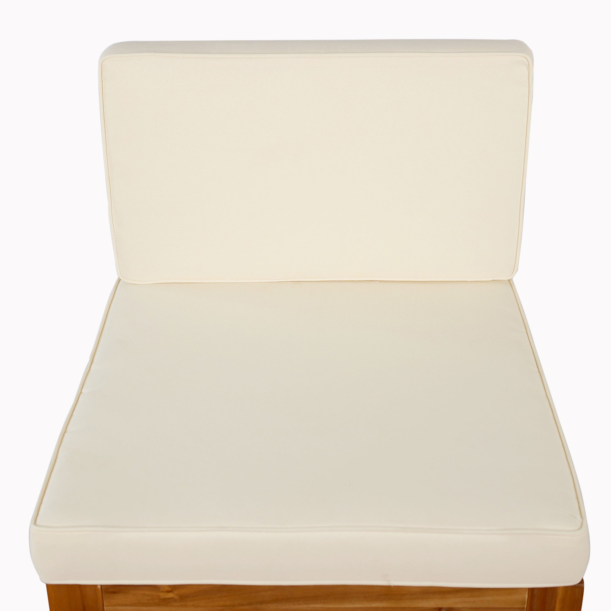 Cream outdoor chair cushion with piped edges on wooden frame