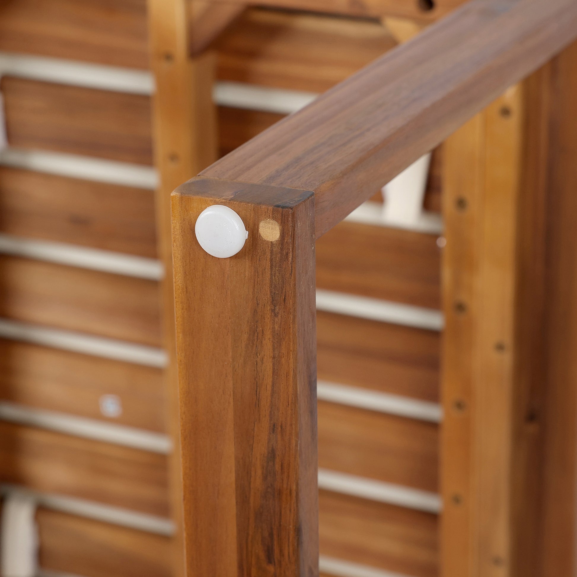 Solid wood patio chair leg with protective white foot cap crafted from durable acacia wood