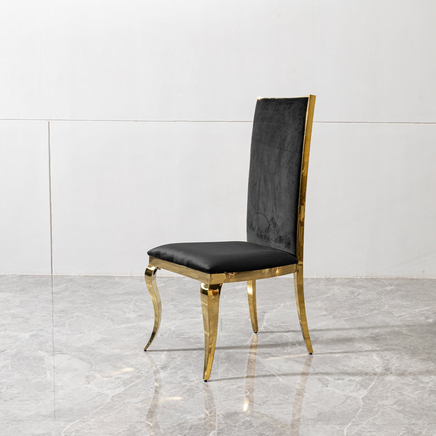Elegant black velvet dining chair with polished gold frame and legs