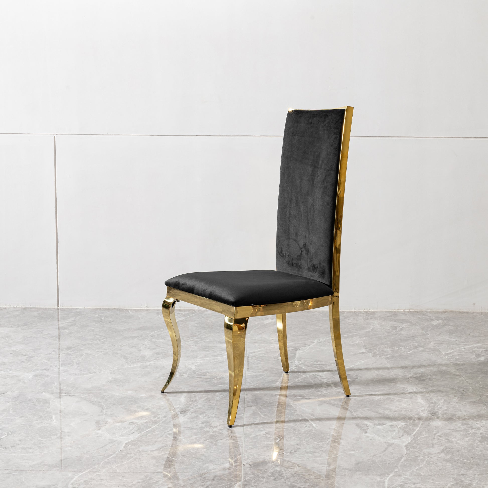 Elegant black velvet dining chair with polished gold frame and legs