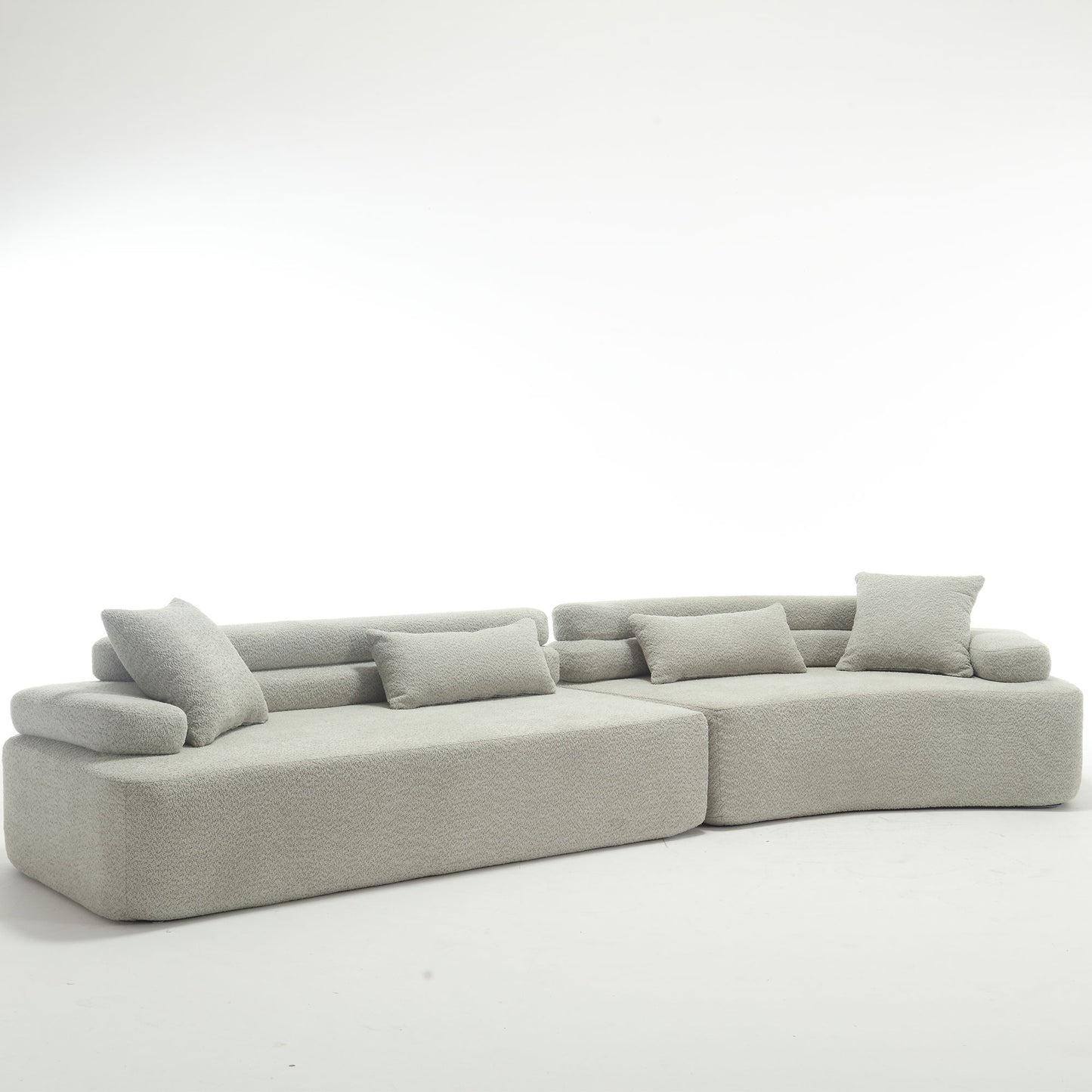 Light grey boucle sectional sofa with plush throw pillows for modern living room comfort