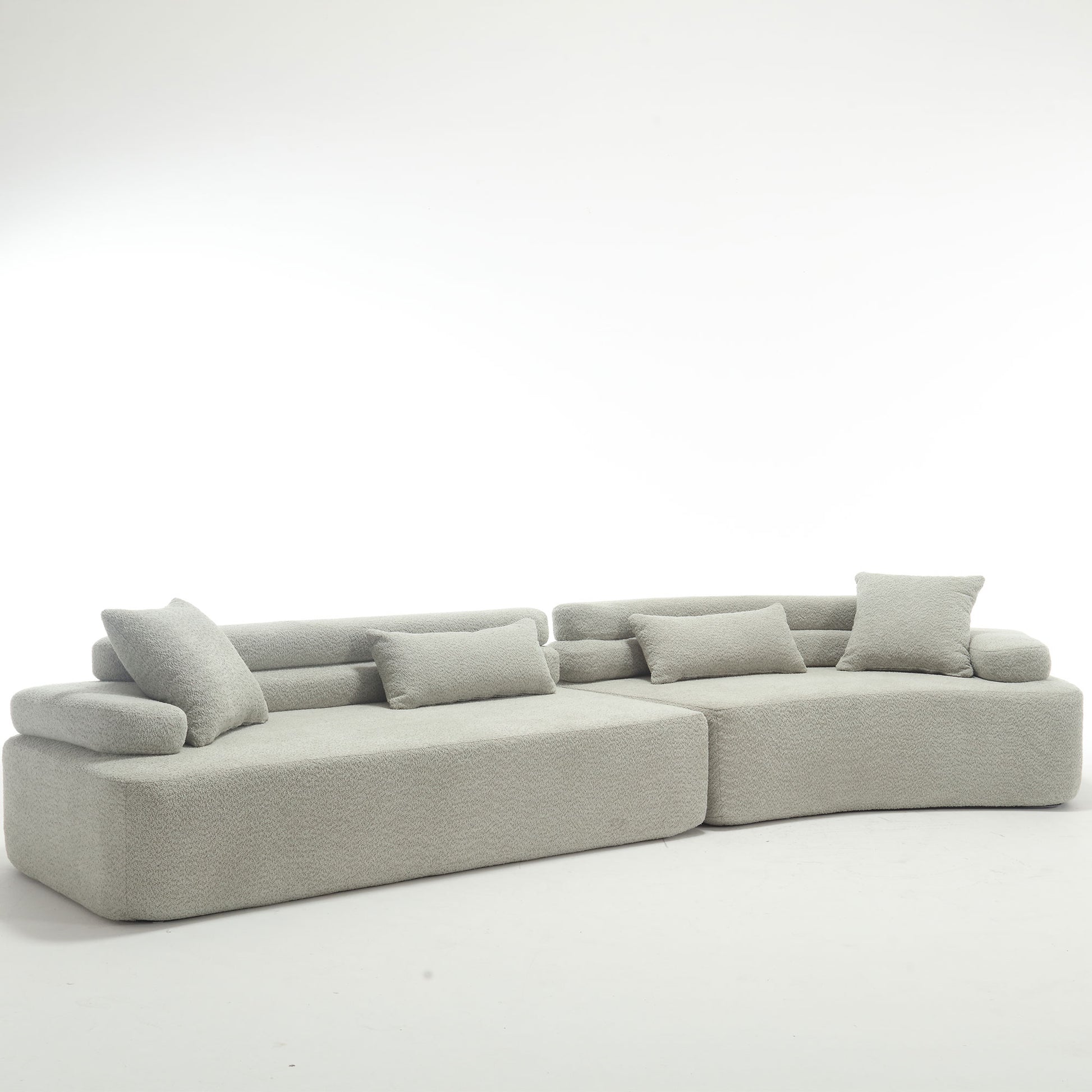 Light grey boucle sectional sofa with plush throw pillows for modern living room comfort