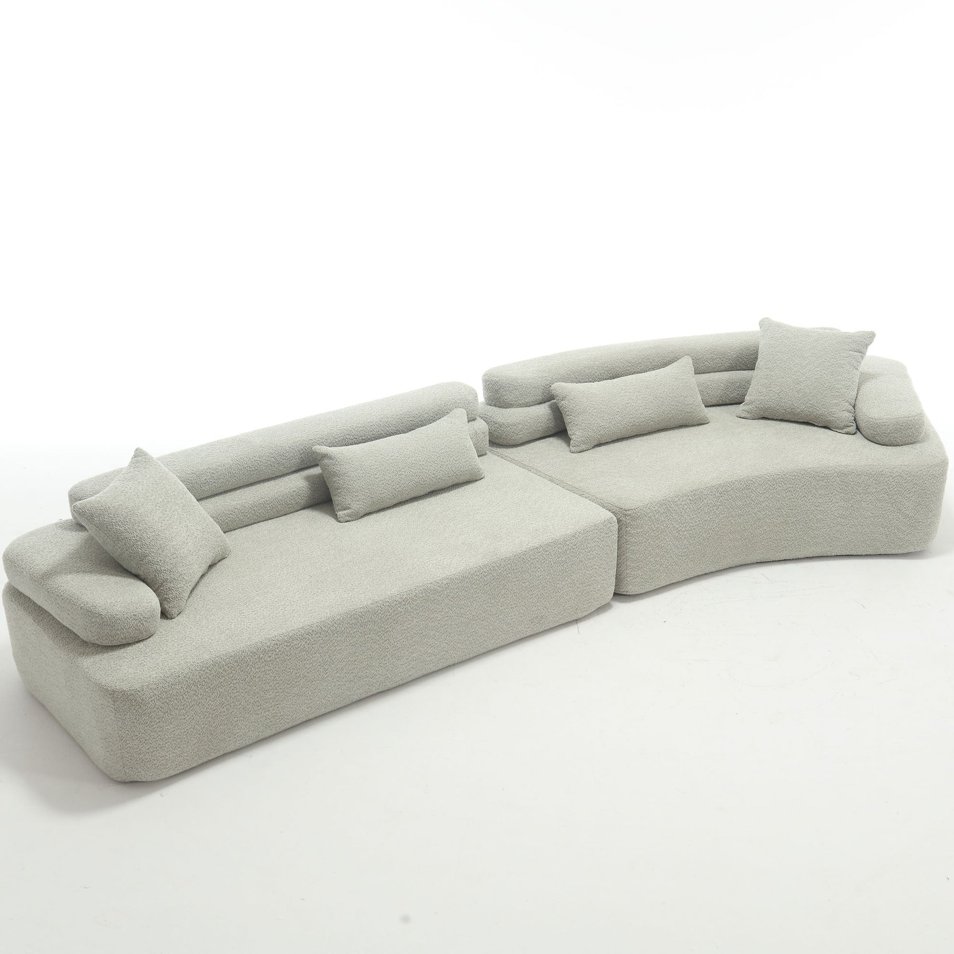 Plush light gray boucle modular sofa with rounded arms and accent pillows for modern living rooms