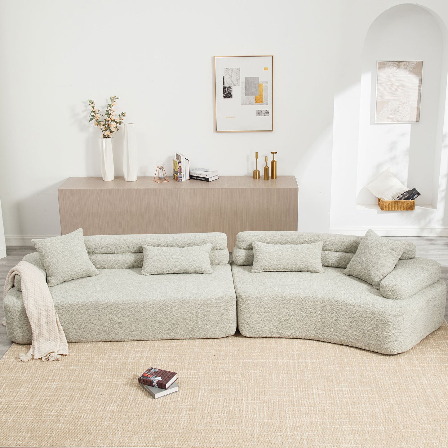 Plush light gray sectional sofa with textured fabric and throw blanket
