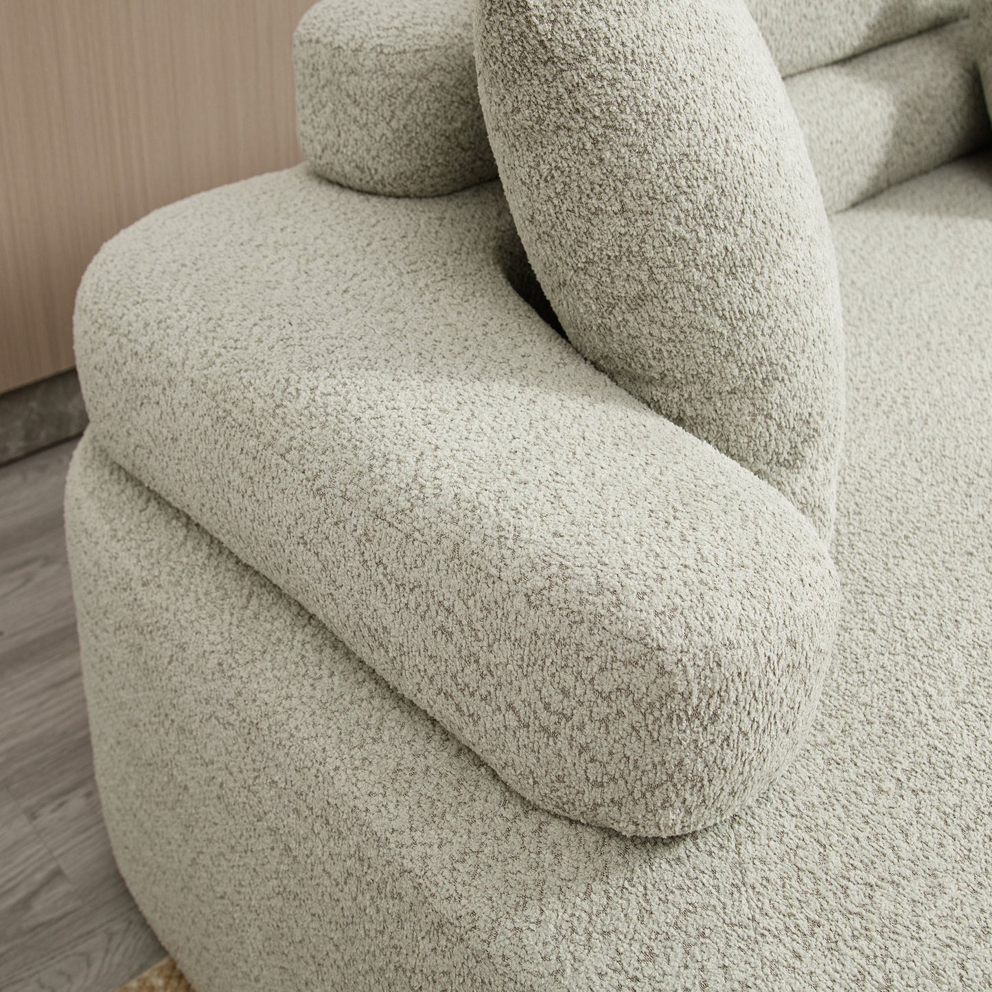 Closeup of a cozy textured boucle fabric sofa in light beige perfect for living room comfort