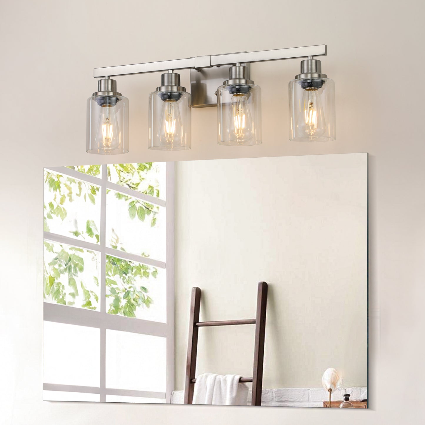 Brushed nickel fourlight vanity light with clear glass shades and exposed bulbs