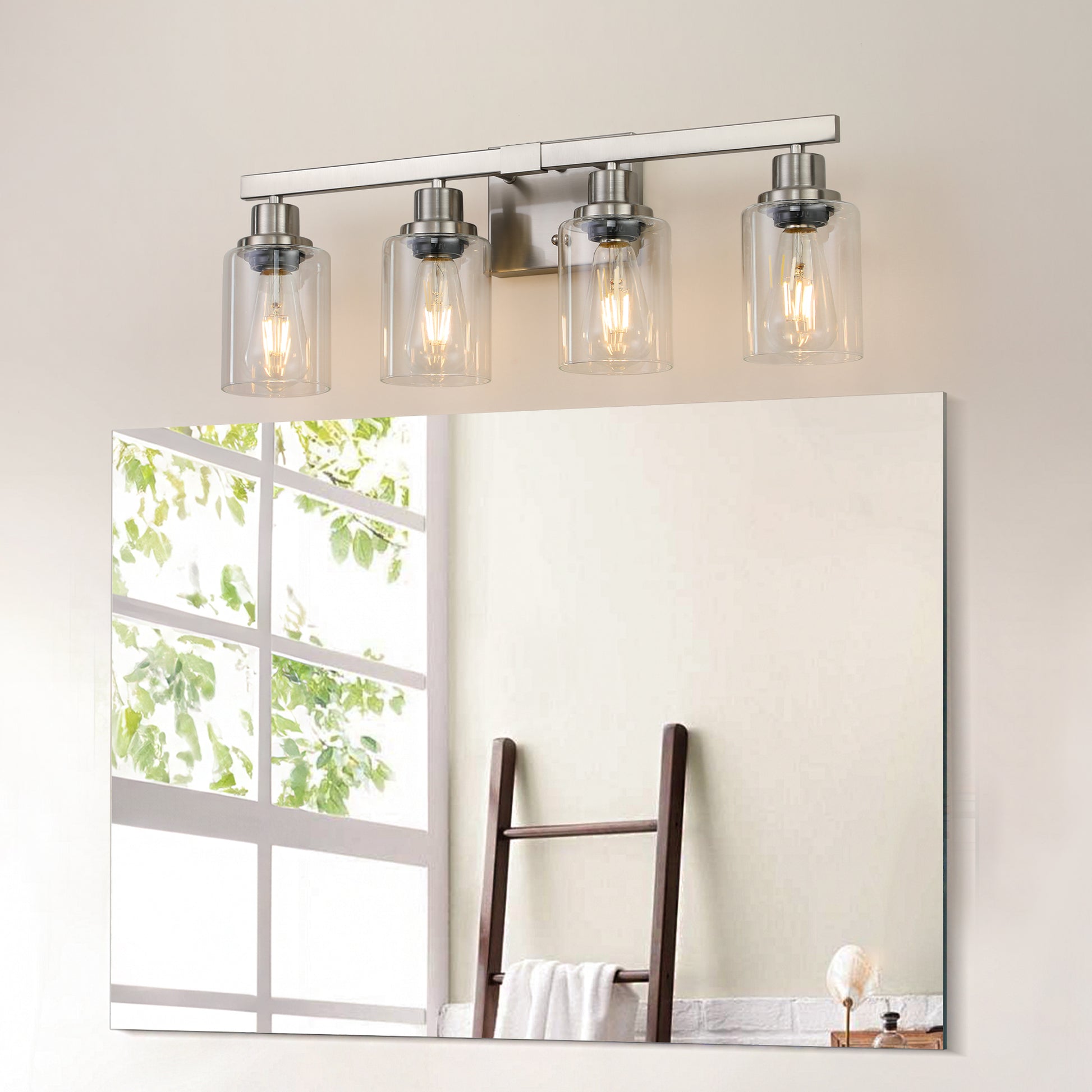 Brushed nickel fourlight vanity light with clear glass shades and exposed bulbs