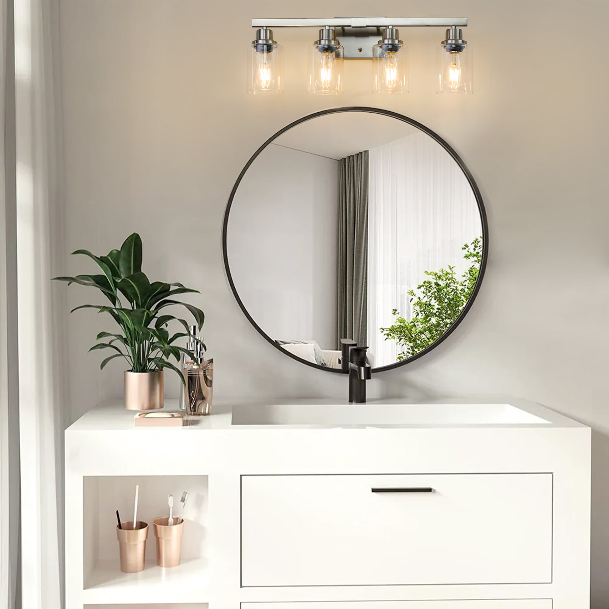 Brushed nickel light vanity light fixture with clear glass shades over Edison bulbs