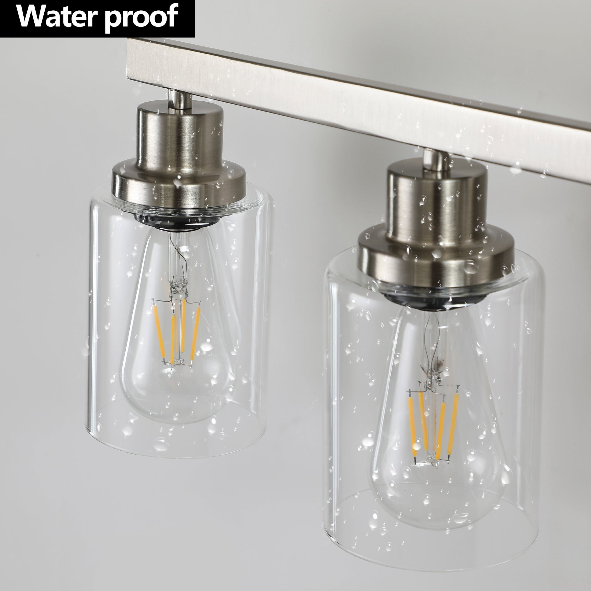 Sleek brushed nickel wall sconce with two clear glass shades and Edison filament bulbs