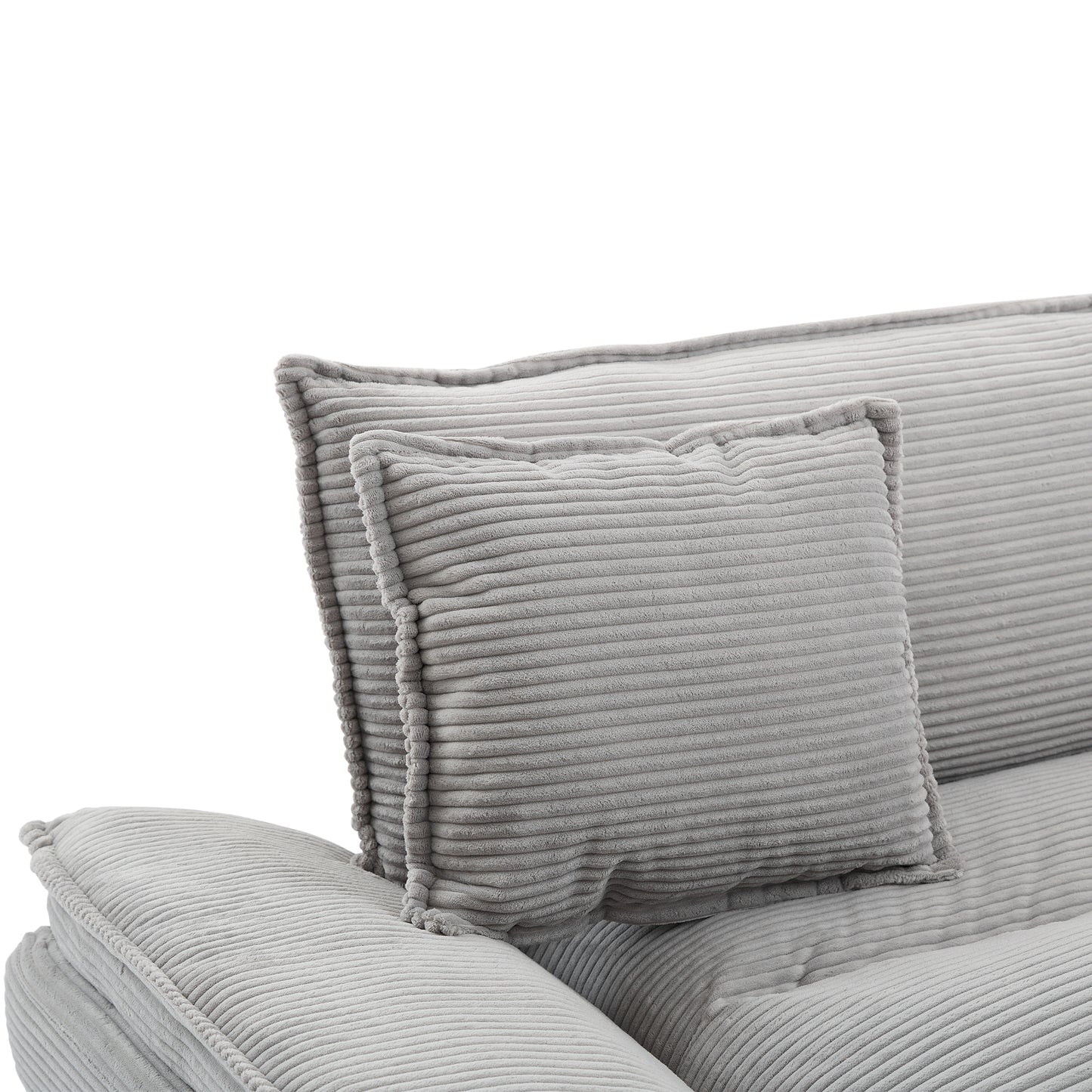 Closeup of a plush grey corduroy sofa section with a lumbar cushion