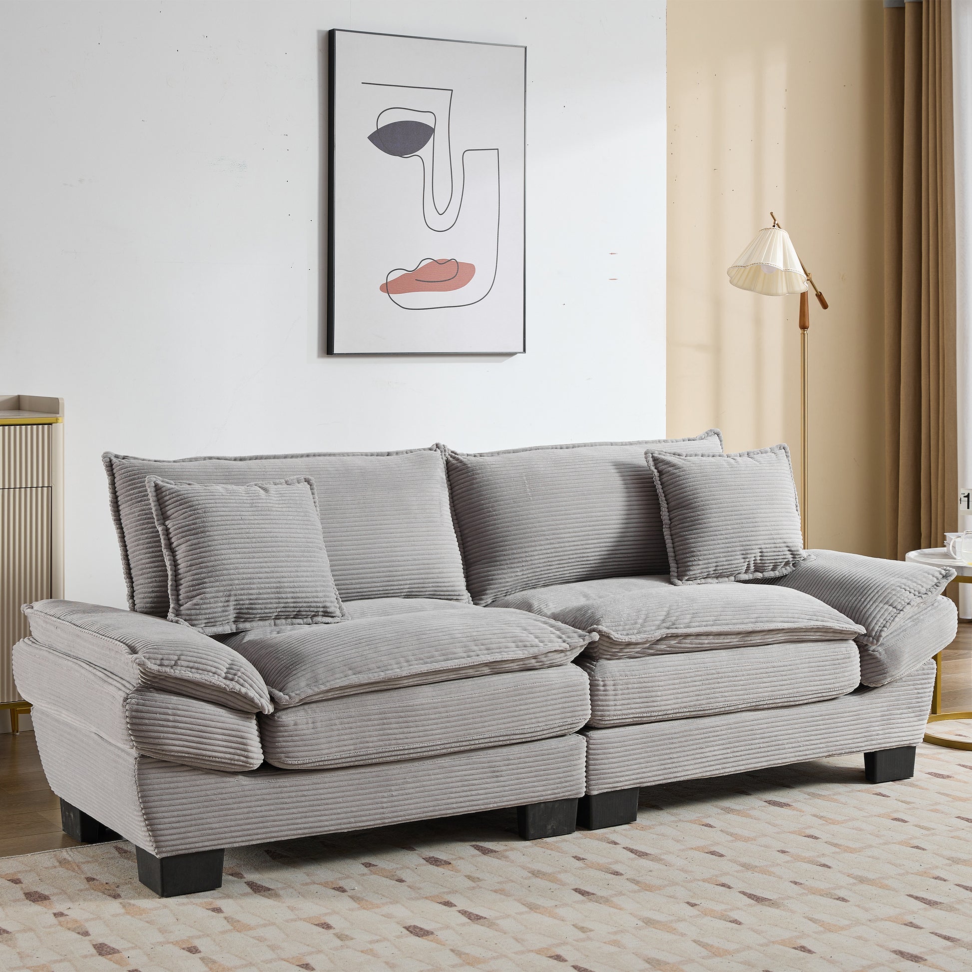 Comfortable gray corduroy sofa with plush cushions and matching throw pillows perfect for living room seating