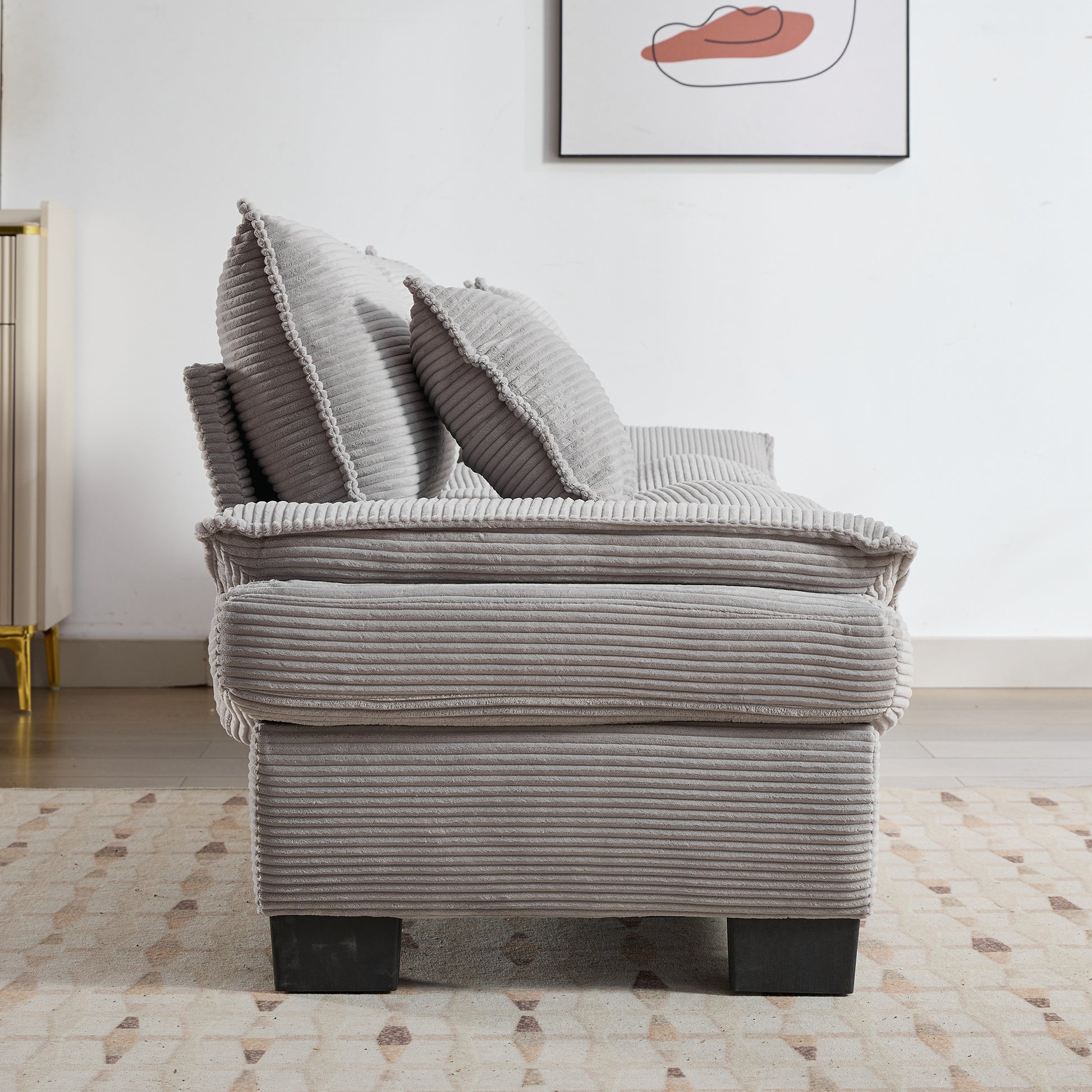 Plush grey corduroy sofa with textured cushions perfect for a cozy living room