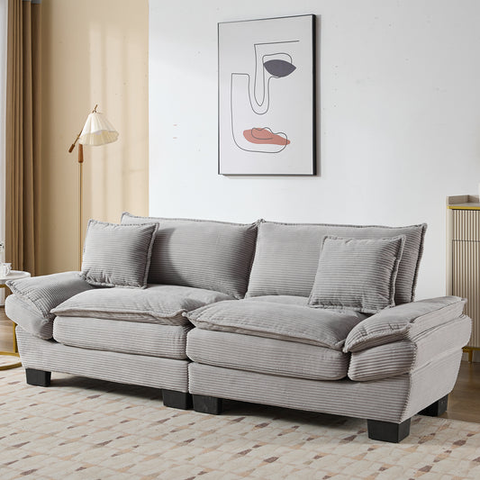 Plush grey corduroy sofa with deep seat cushions and matching throw pillows perfect for living rooms