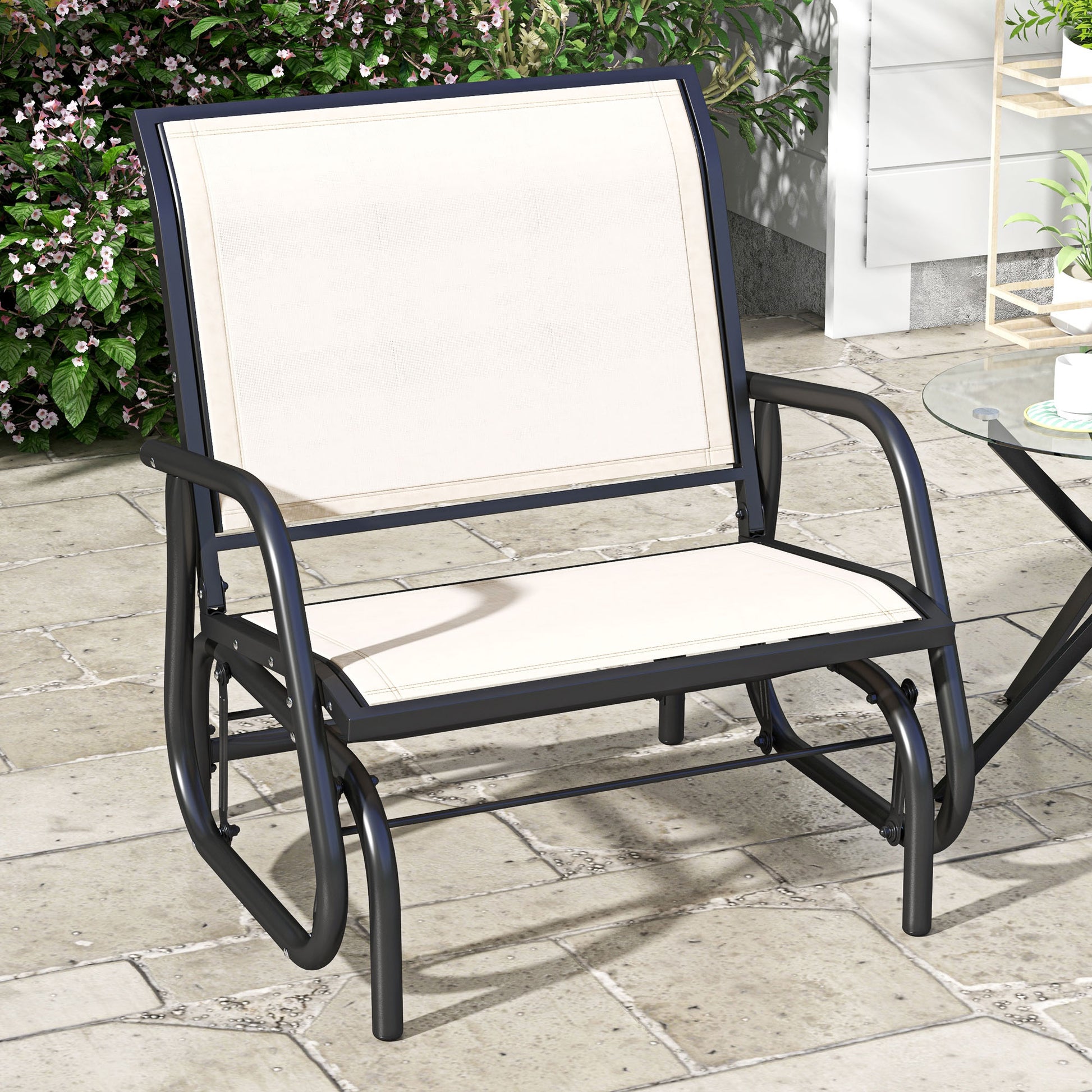 Black metal patio glider chair with cream fabric seating perfect for outdoor relaxation