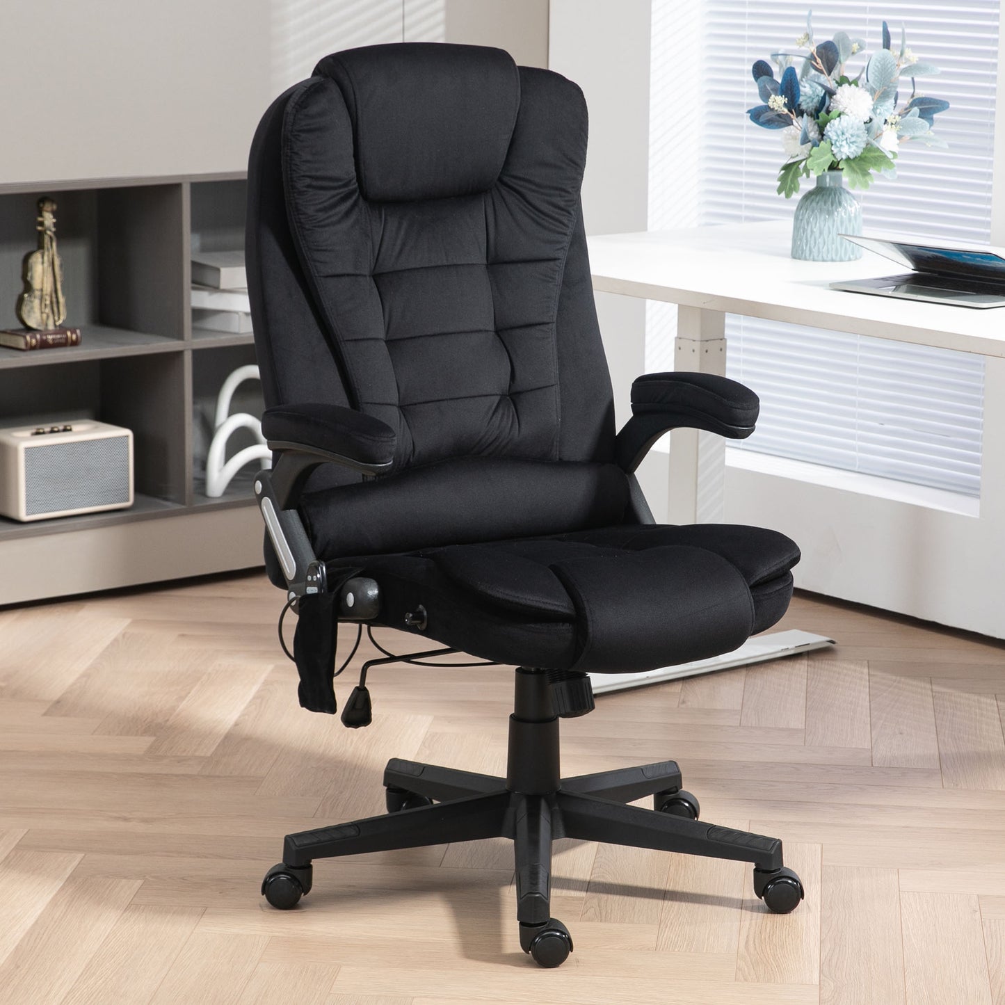 Black ergonomic office chair with plush padding and adjustable armrests for comfortable desk work