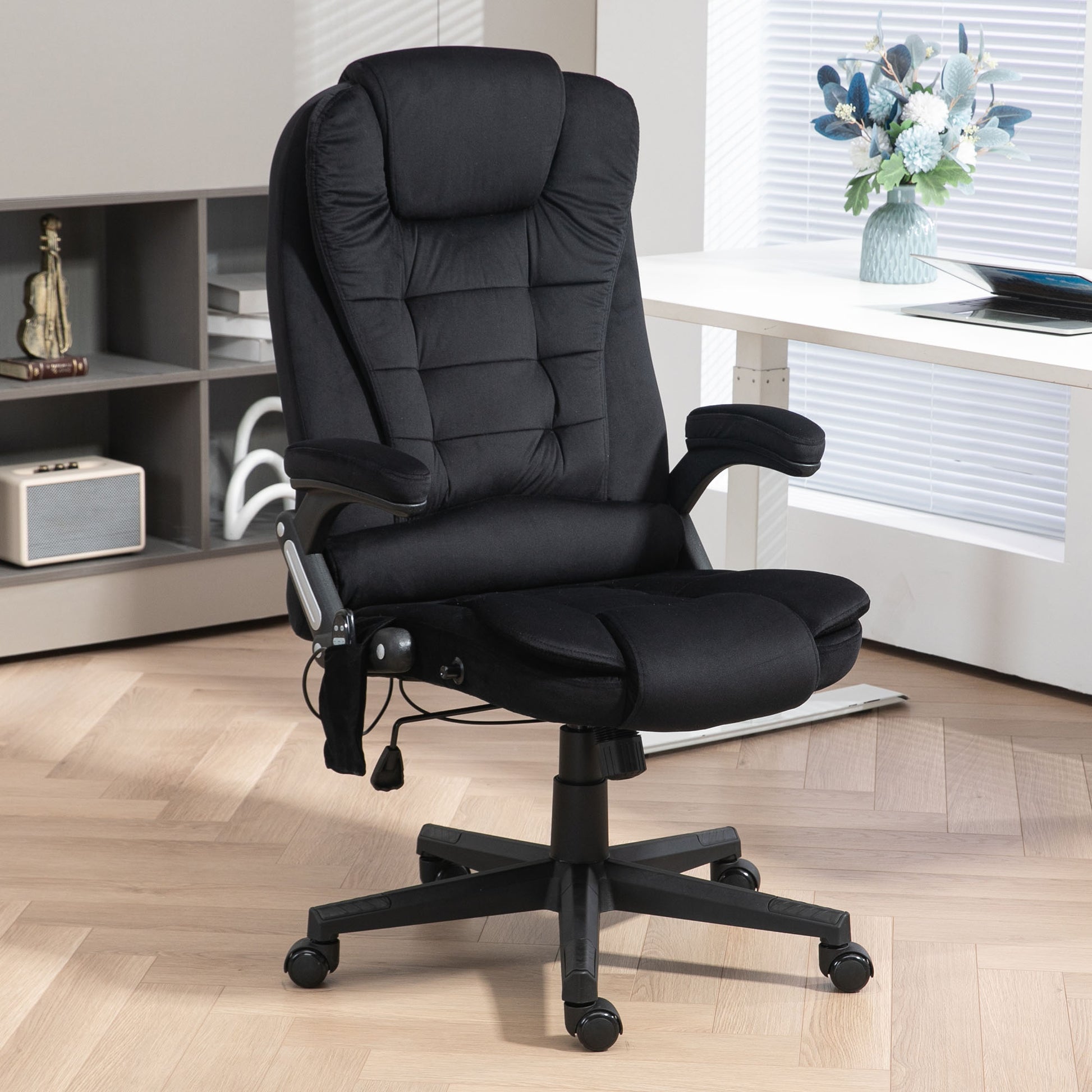 Black ergonomic office chair with plush padding and adjustable armrests for comfortable desk work