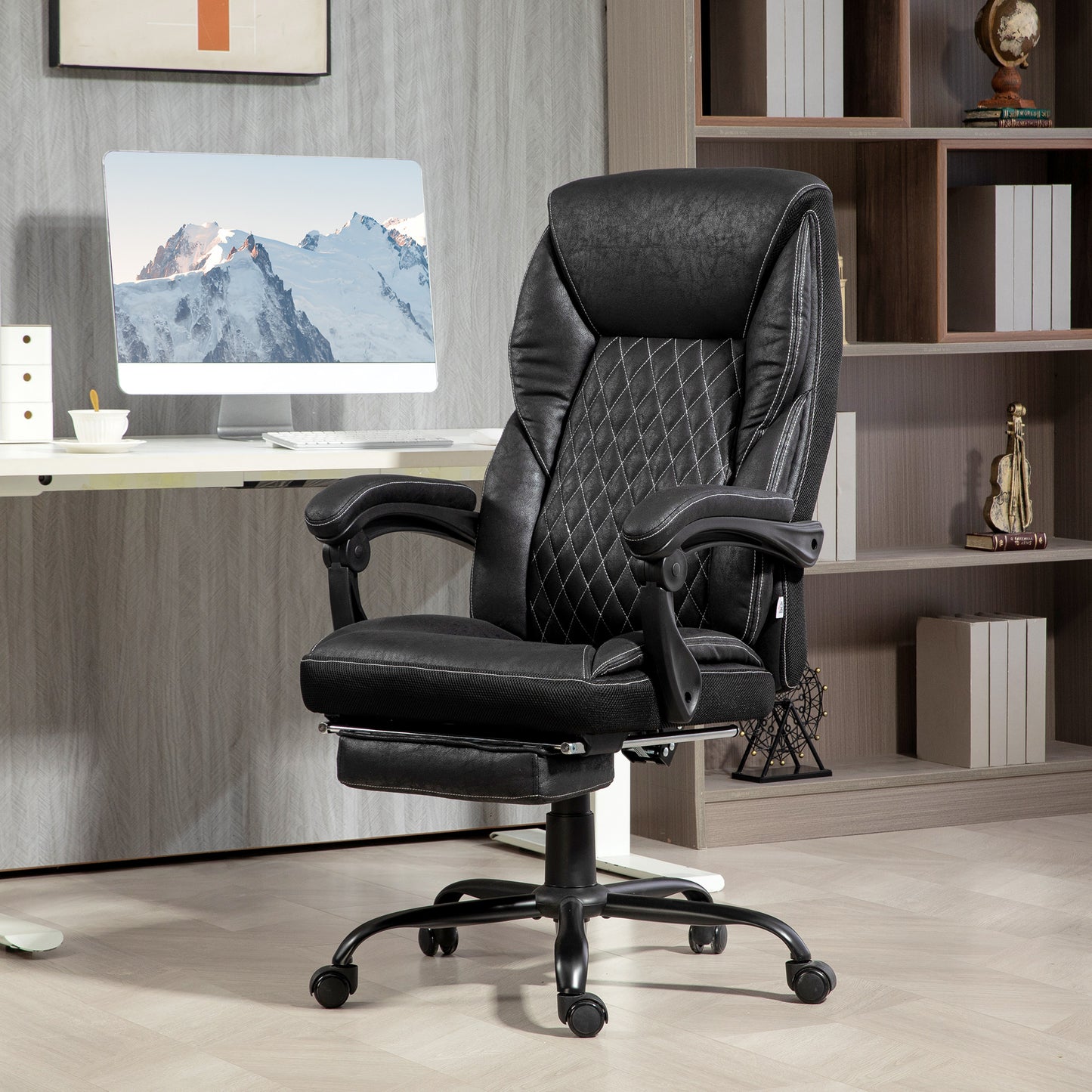 Black executive office chair with diamond stitching and retractable footrest
