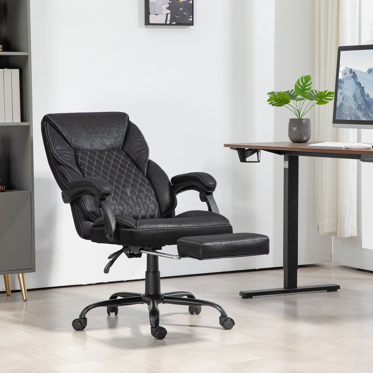 Black ergonomic gaming chair with retractable footrest and diamond stitching