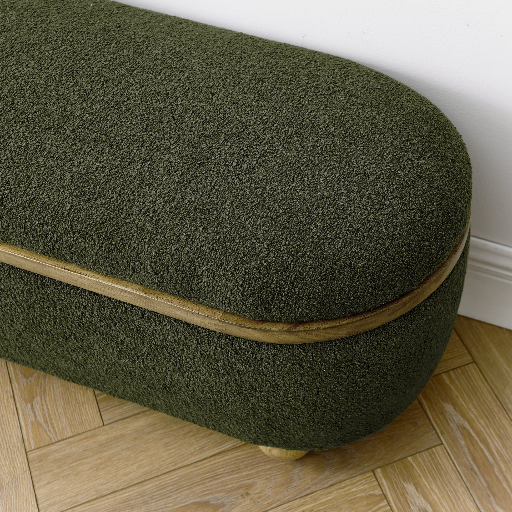 Textured forest green oval bench with natural wood accent and carved legs