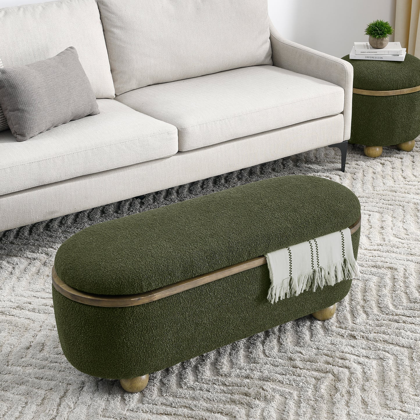 Oval green boucle storage ottoman with wooden trim and brass legs perfect for living rooms