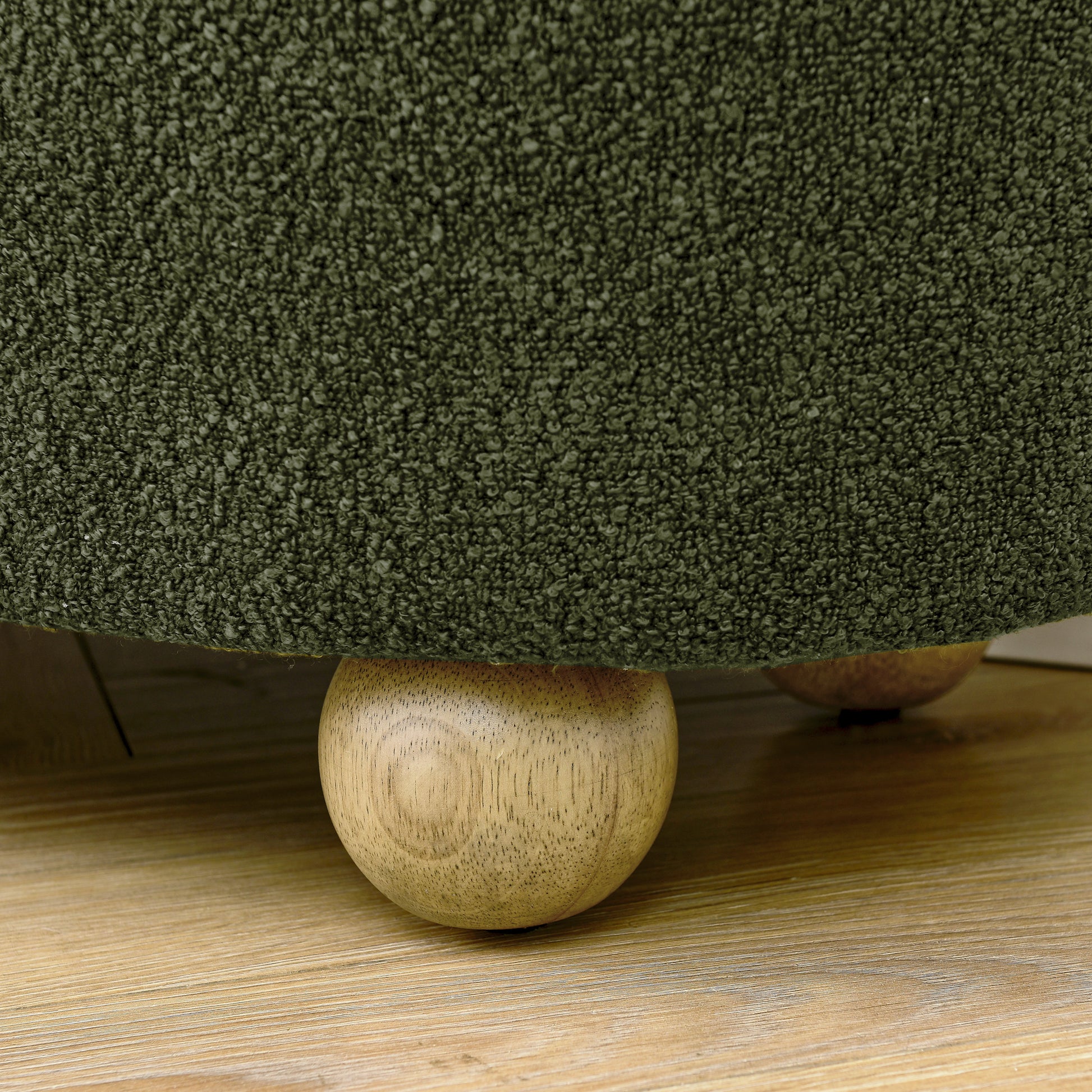 Textured forest green boucle fabric sofa with round wooden legs