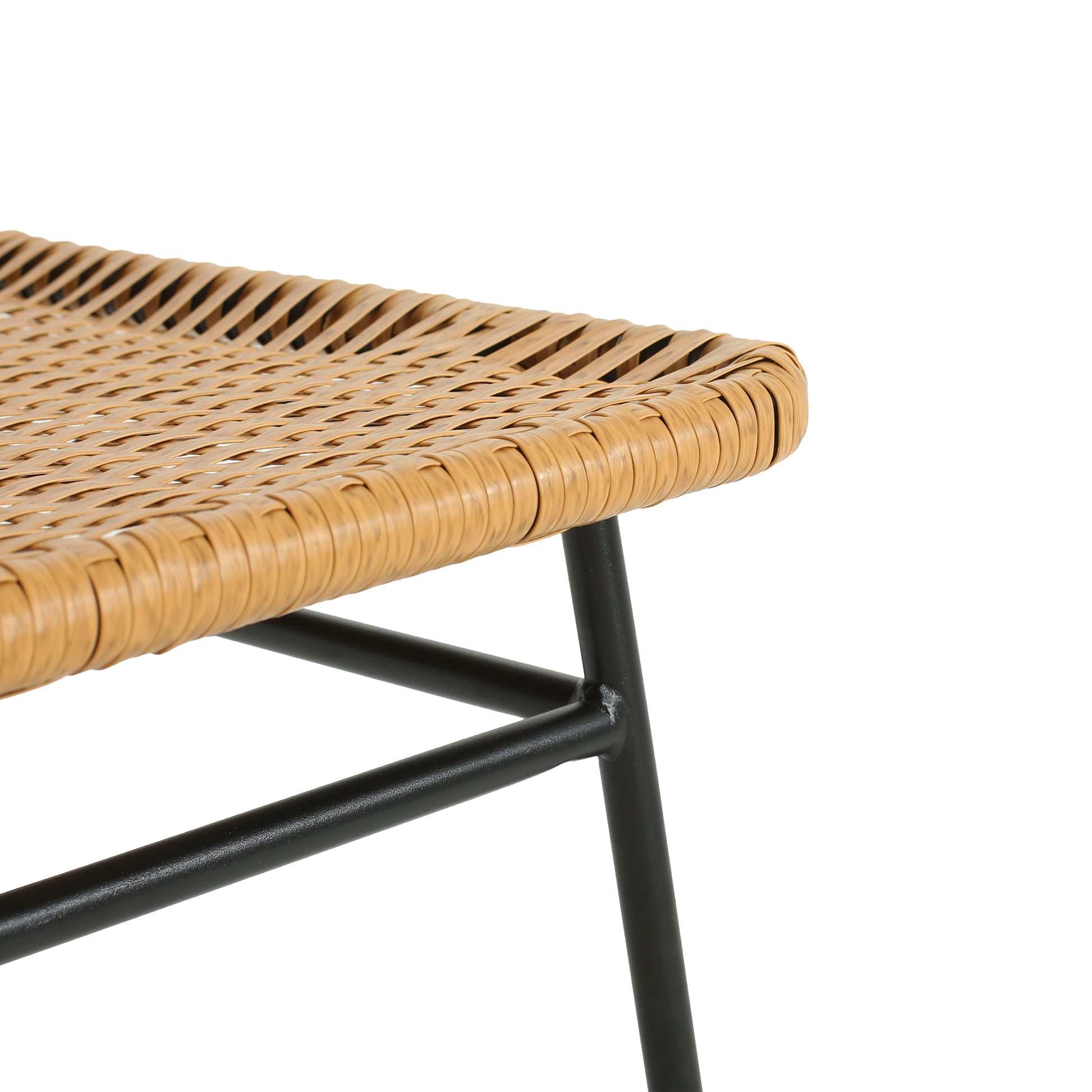 Close up of a tan rattan seat on a modern black metal frame stool