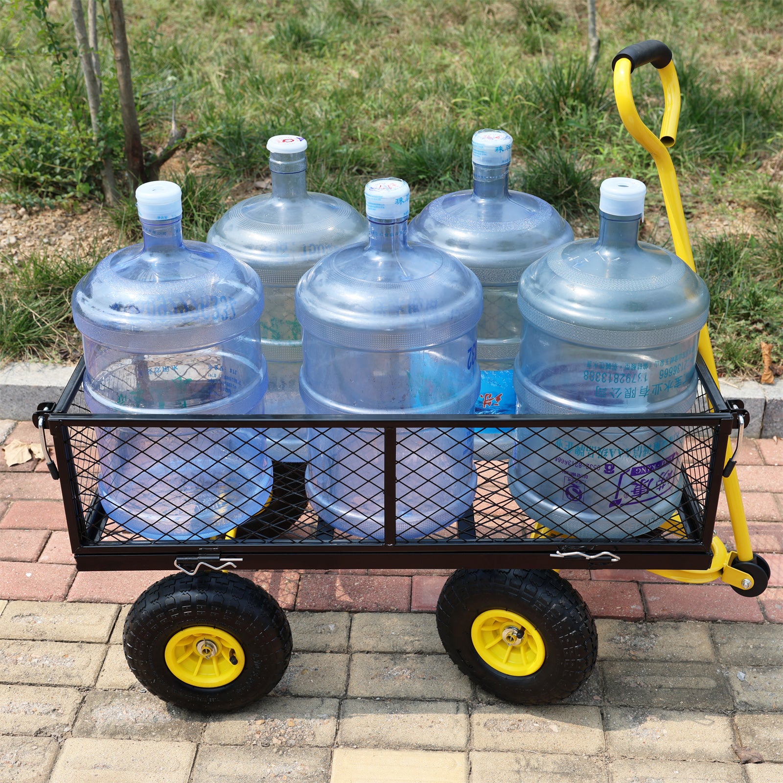Black metal wagon with large blue water cooler jugs and yellow handle